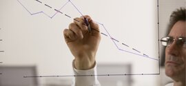 man drawing a line graph