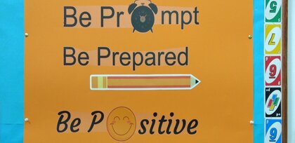 poster on wall saying be prompt, be prepared, be positive