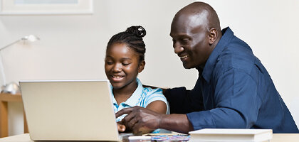 dad and daughter with computer