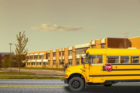 school with a bus in the foreground