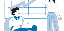 Person on computer in a chair another person pointing at a graph